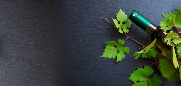 istock White wine bottle and fresh grape leaves 1008888878