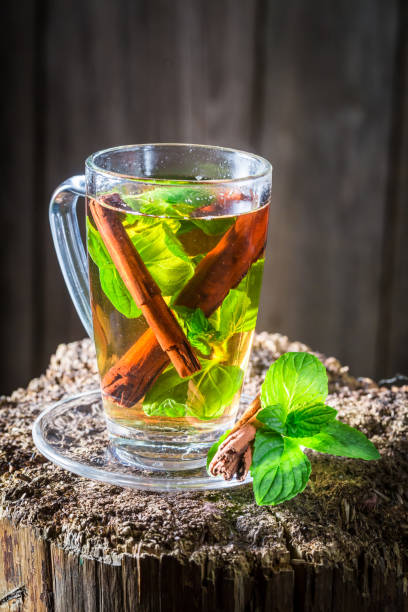 istock Hot and fresh tea with cinnamon bark and green leaves 1008891780