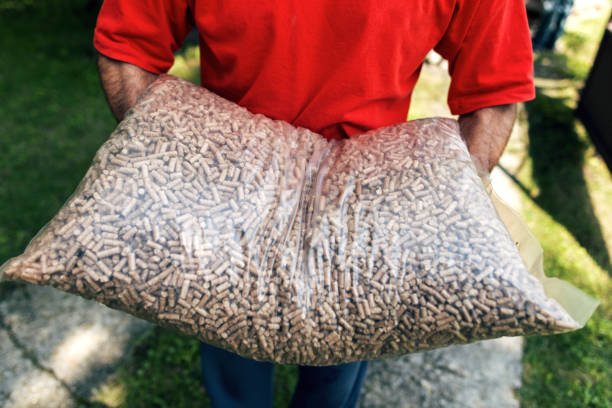 Man carrying wood pellets in hands