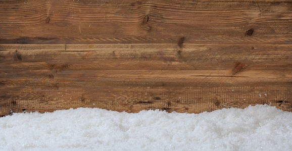 Snow on wooden background with copy space