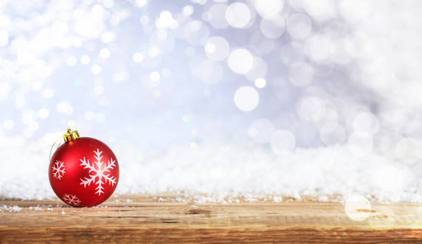istock Red Christmas ball on a wooden table 1008906452