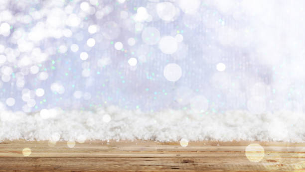 istock Wooden surface Christmas snowy background 1008906476