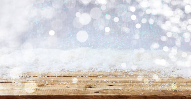 istock Wooden surface Christmas snowy background 1008906482