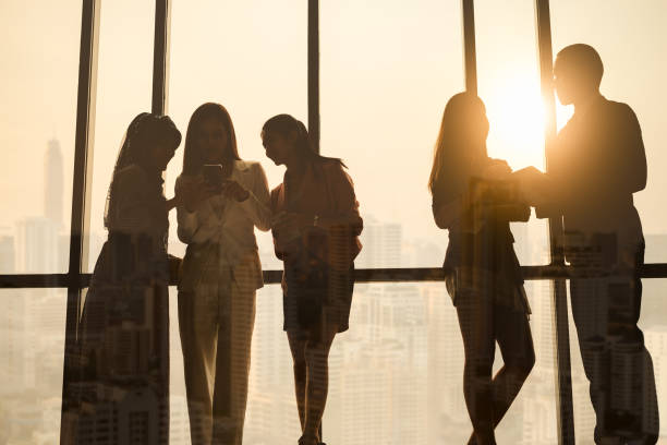 istock Silhouette diverse business people working over city background with double exposure 1008908752