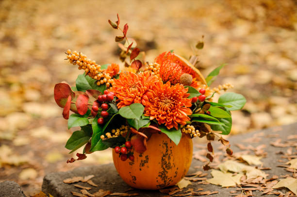 istock Beautiful pumpkin with an autumn flower composition 1008909240