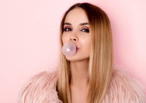 istock Blonde woman blowing bubble gum 1008913670