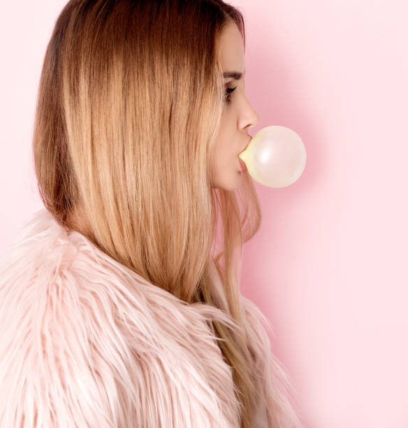 istock Blonde woman blowing bubble gum 1008913688