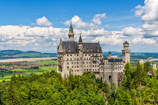 Hohenschwangau, Germany - June 10, 2018: The idyllic Neuschwanstein Castle positioned high up on a mountain in the Bavarian Alps. Commissioned by King Ludwig II of Bavaria.