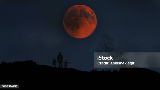 A Family Enjoying The 2018 Lunar Eclipse Stock Photo - Download Image Now - Moon, Moon Surface, Total Lunar Eclipse