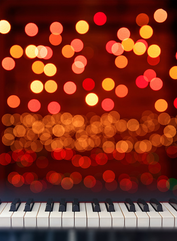 Classical Piano keyboard front view on Christmas lights bokeh background