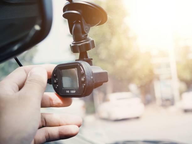 istock hand holding the camera of front a car 1008917824