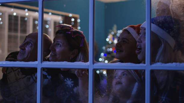 istock Happy family watching fireworks through window 1008920140