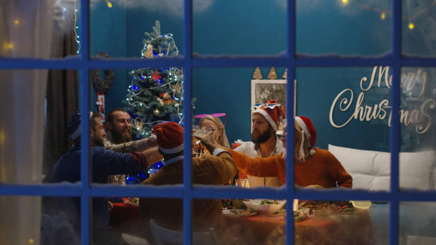 istock View through window of people celebrating Christmas 1008922244