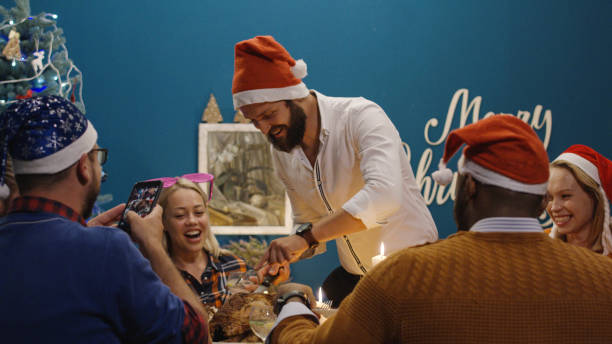 istock Laughing friends having roasted turkey at Christmas dinner 1008922314