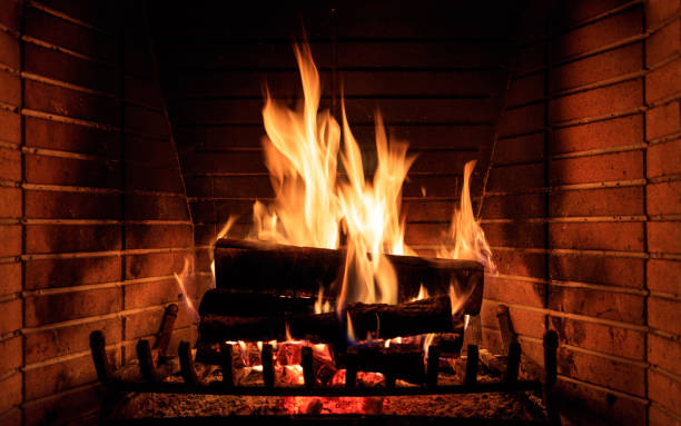 burning fireplace at home - fire place imagens e fotografias de stock