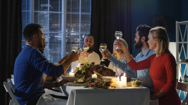 istock Friends toasting at table on Thanksgiving day 1008922624