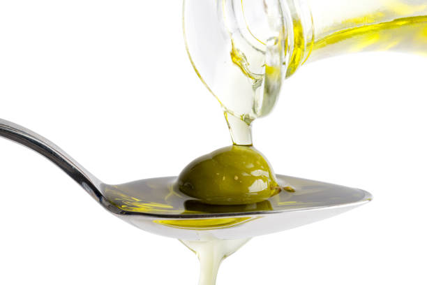 istock Pouring olive oil on spoon 1008939410