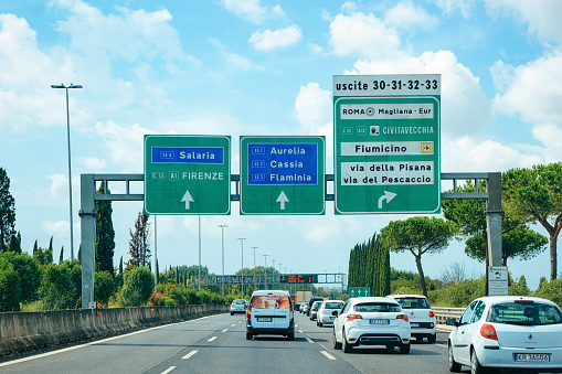 Rome, Italy - September 7, 2017: Cars and traffic signs to Firenze and Roma in the road in Italy