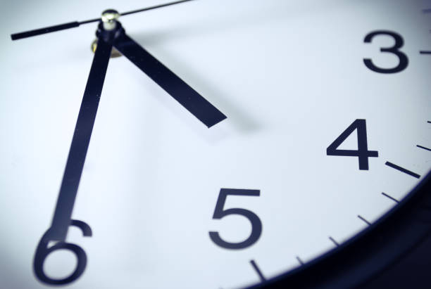 istock Close up of black and white analog clock selective focus at 4:30 with vintage filter 1008961046
