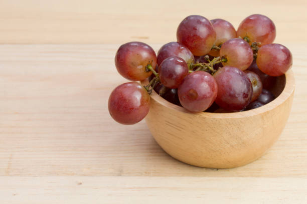 istock group of fresh red grape in bowl on wood table 1008987528