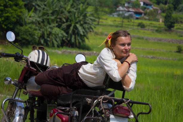 istock young woman relaxes sunbathing on a red motorcycle 1008987578