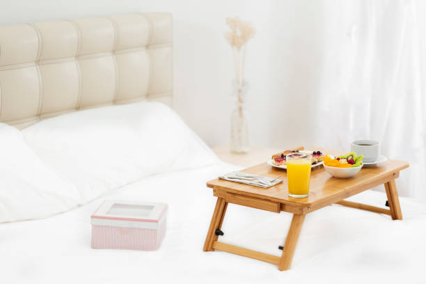 istock Romantic surprise. Breakfast in bed and a gift 1008987838