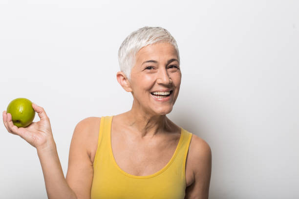istock Smiling old woman holding an apple 1008988062