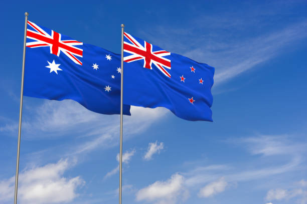 New Zealand and Australia flags over blue sky background. stock photo