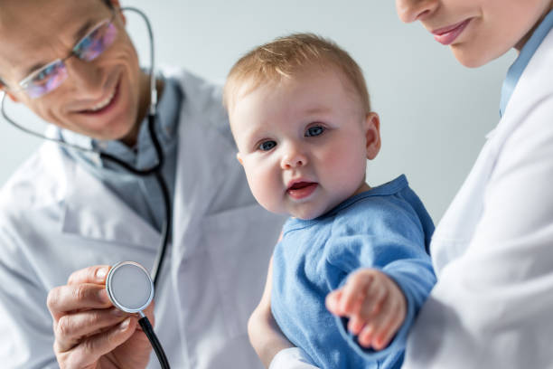 cropped shot of pediatricians checking breath of adorable little baby cropped shot of pediatricians checking breath of adorable little baby pediatrician stock pictures, royalty-free photos & images