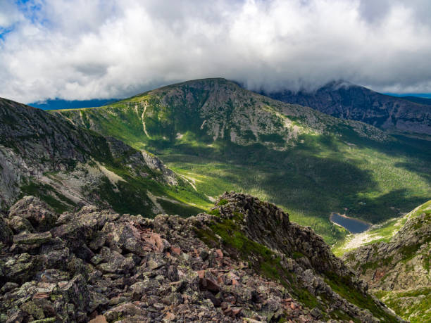 Mountain Range and Valley Below, Forest Pond, Katahdin, Maine A view of the valley and mountain ridge from the Knife's Edge of Katahdin in Baxter State Park in Maine. mt katahdin stock pictures, royalty-free photos & images