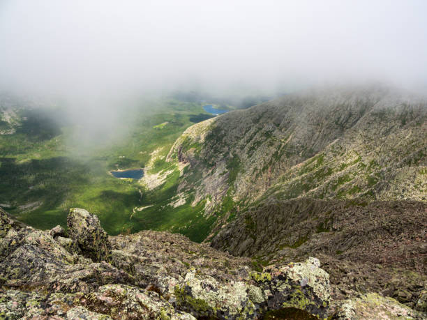 Valley View, Mountain Ridge, Clouds, Forest Pond, Katahdin, Maine A view of the Chimney Pond are through the clouds, from the top of the Knife's Edge trail on Katahdin in Baxter State Park in Maine. mauer park stock pictures, royalty-free photos & images
