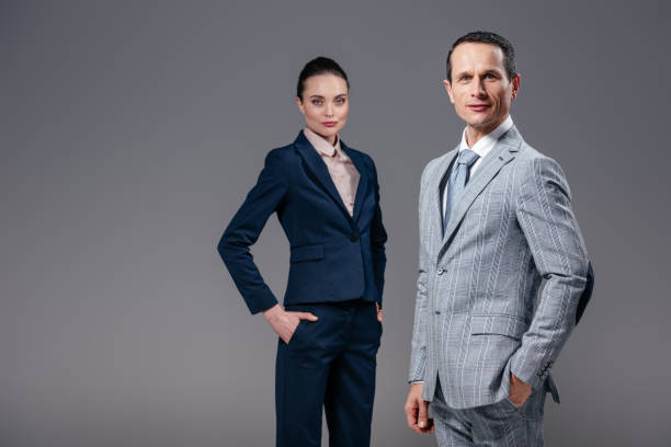 istock confident adult business people looking at camera isolated on grey 1009023098