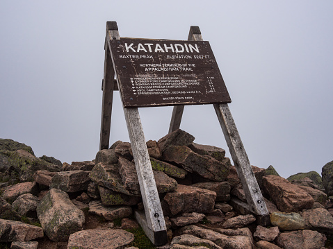An image of the trail sign that marks the northern terminus of the Appalachian Trail on Katahdin in Baxter State Park in Maine.