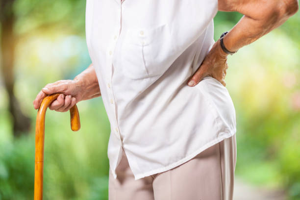 istock Elderly woman outdoors with back pain 1009027746
