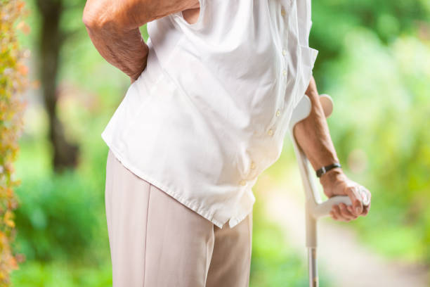 istock Elderly woman outdoors with back pain 1009027800
