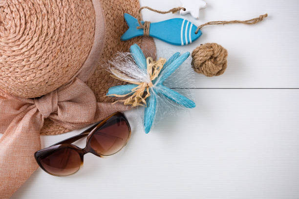 istock Sunglasses, hat and summer accessories on white wood background 1009031734