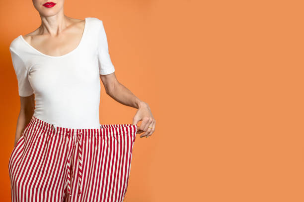 istock Woman shows her loss weight 1009036320