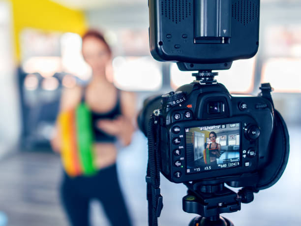 istock Women doing an exercise vlog - fitness workout with stretch bands. 1009036918