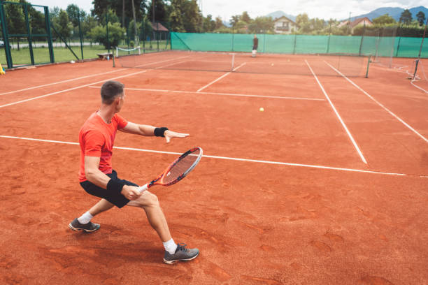 istock Two friends on tennis court 1009042698