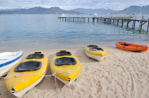 istock kayak and small boat on the beach 1009046212
