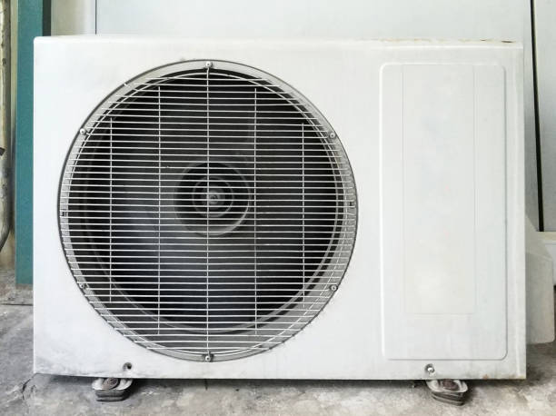 istock Air conditioning outdoor compressors hanging on wall 1009059294