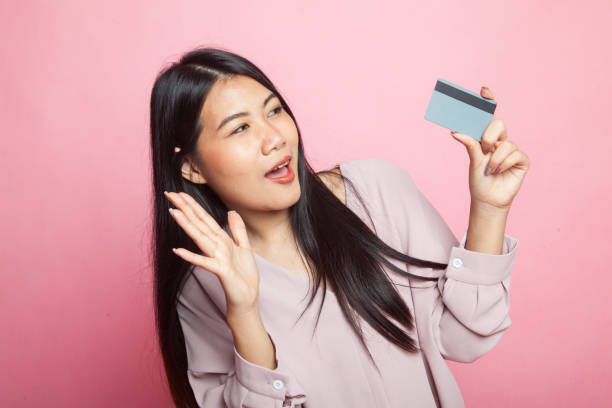 istock Young Asian woman happy with  blank card. 1009060322