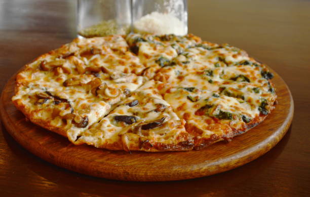 istock pizza topping mushroom and spinach cheese with seasoning bottle 1009067248