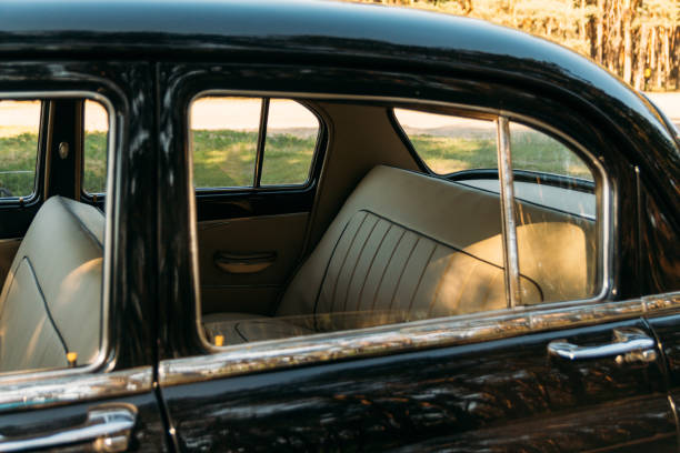 istock machine black, inside the seat of beige leather, retro car. 1009077322