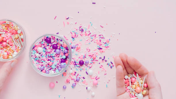 istock Colorful sprinkle blend on a pink background. 1009078260
