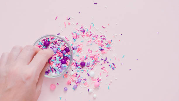 istock Colorful purple sprinkle blend on a pink background. 1009078264