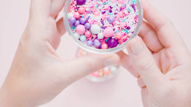 istock Colorful purple sprinkle blend on a pink background. 1009078276