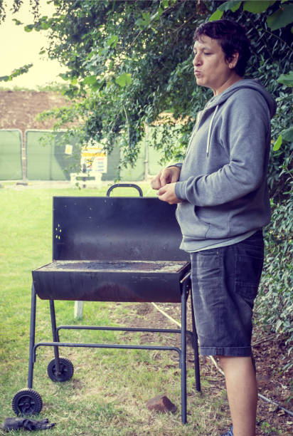 Man ready to start Cooking A Barbeque In a camping