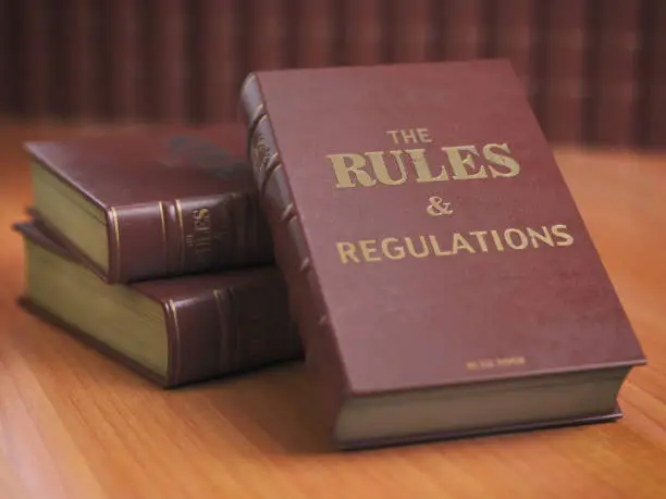Photo of Rules an regulations books with official instructions and directions of organization or team.