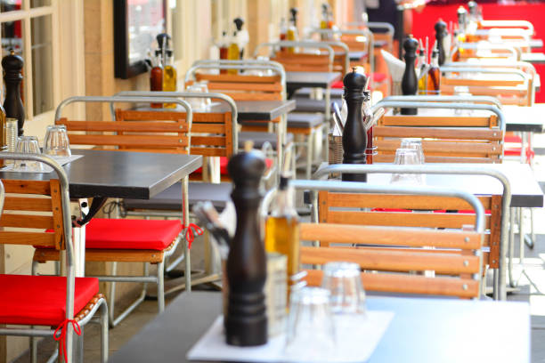 istock Tables and chairs on pavement outside bistro 1009098256